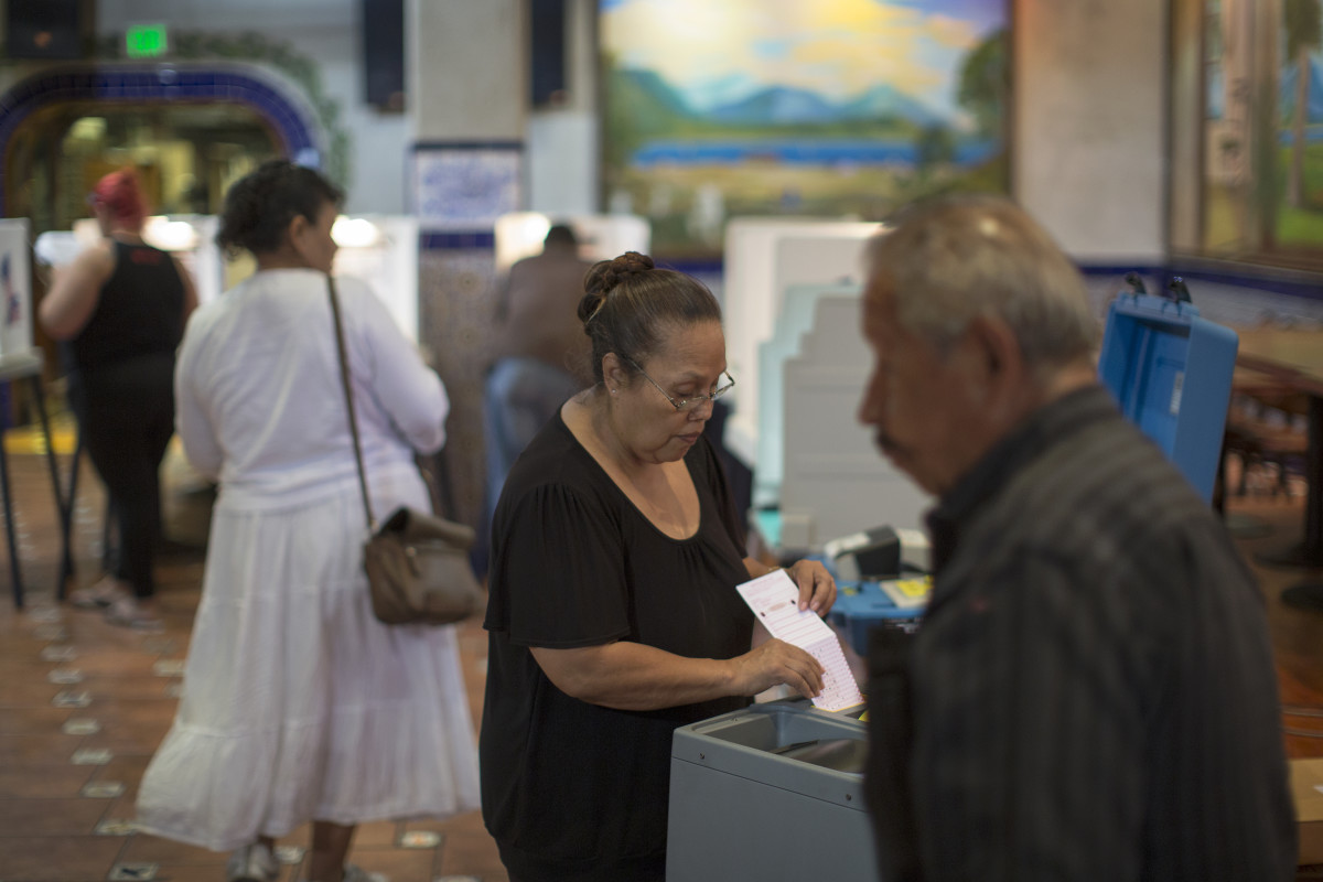 Latinos vote at a polling station in El Gallo Restaurant on November 8th, 2016, in the Boyle Heights section of Los Angeles, California.