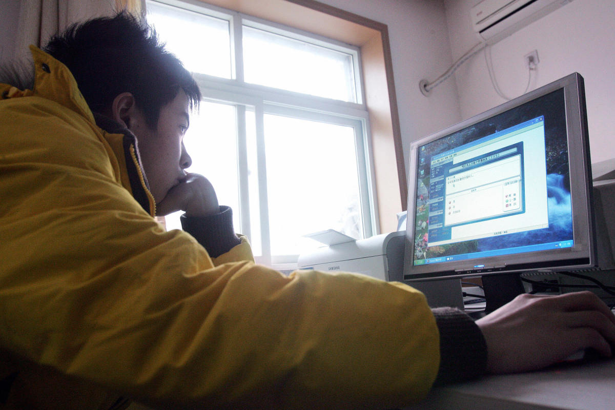 A teenager using a computer.