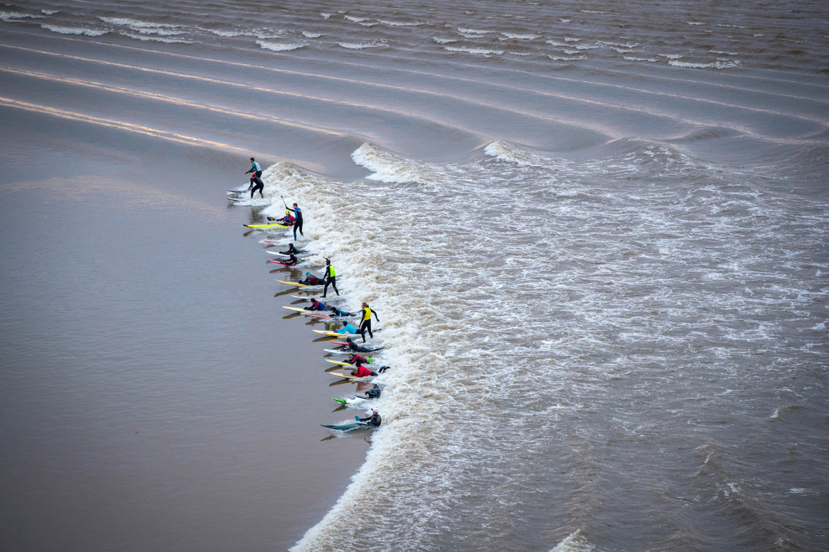 Surfers attempt to ride the Severn Bore on the River Severn on February 2nd, 2018, in Gloucestershire, England. The bore, which follows this week's supermoon, attracts surfers from around the world.