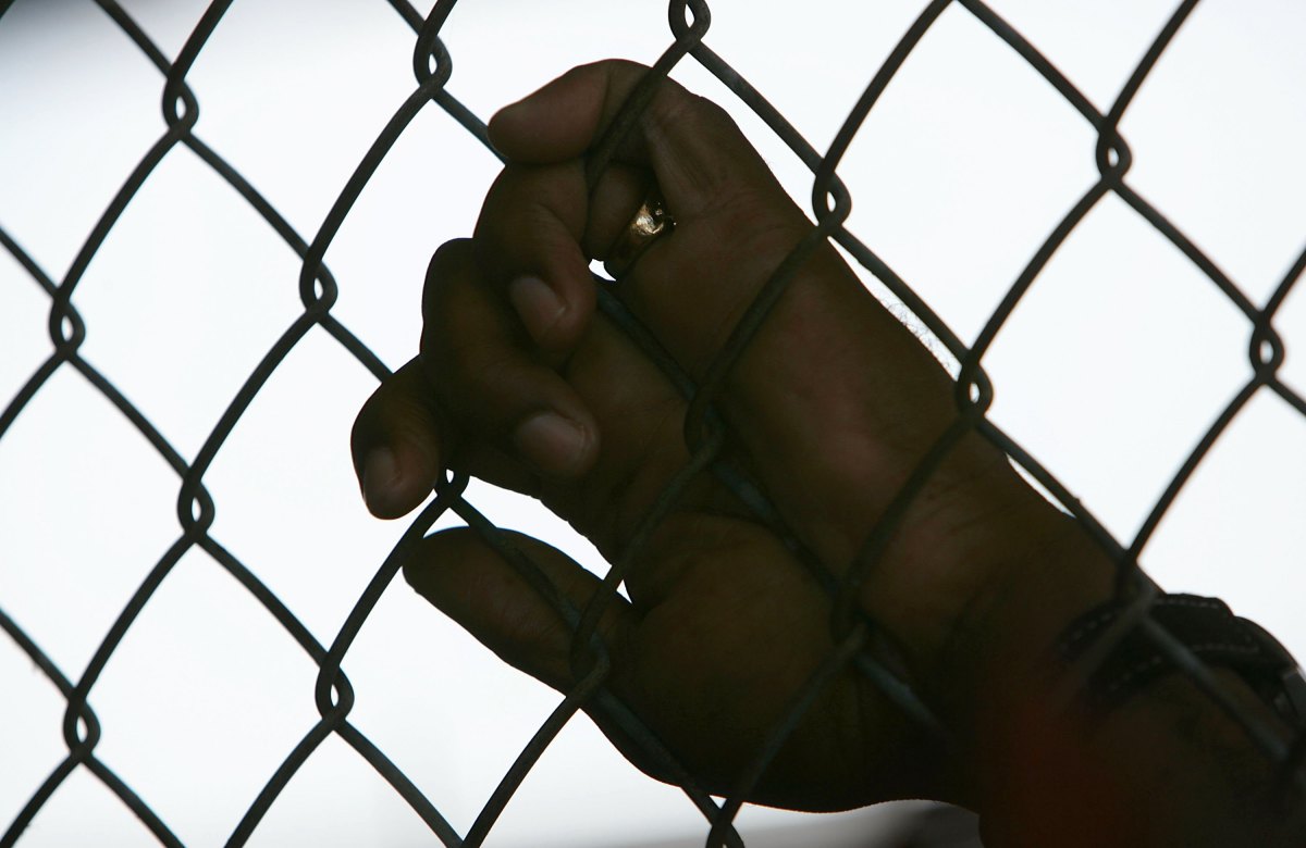 An inmate holds onto a fence at the Louisiana State Penitentiary in Angola, Louisiana.