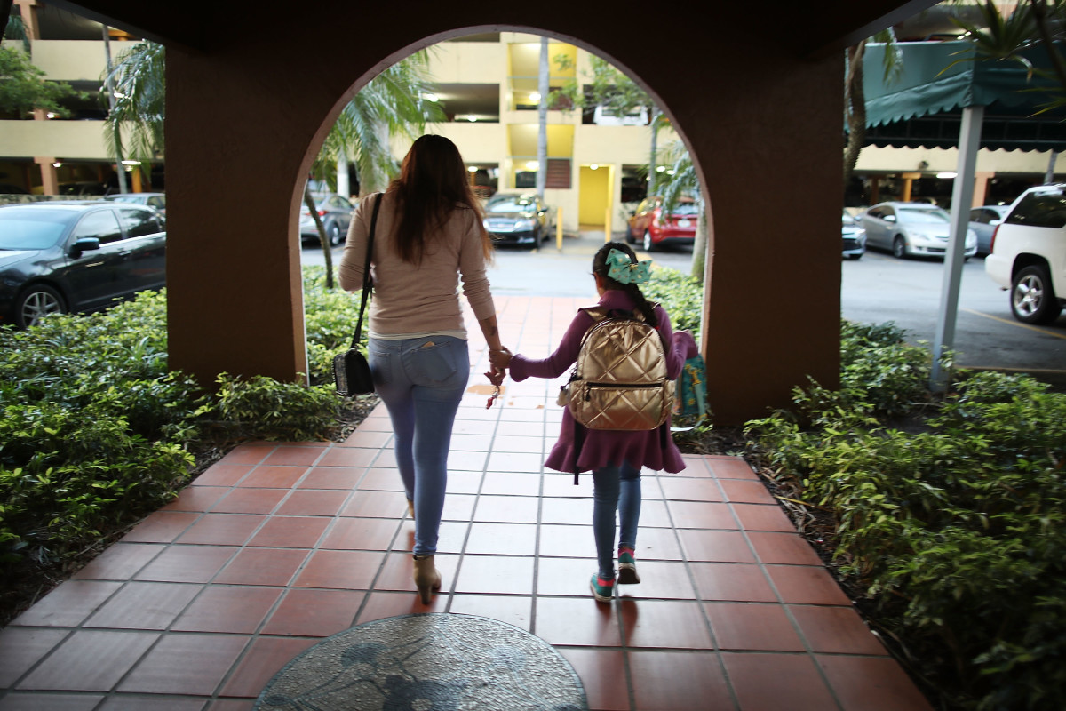 An immigrant woman takes her daughter to school before going to work on February 9th, 2018, in Miami, Florida.