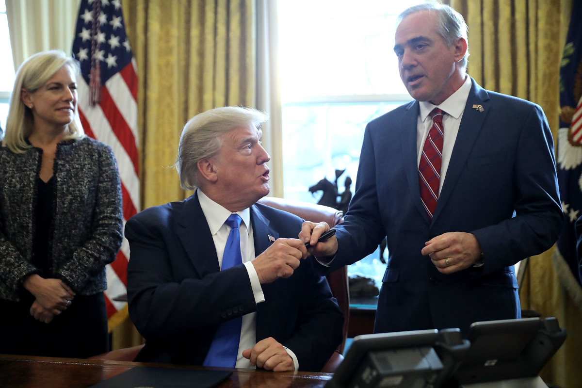 U.S. President Donald Trump gives the pen he used to sign an executive order supporting veterans as they transition from military to civilian life to Veterans Affairs Secretary David Shulkin.