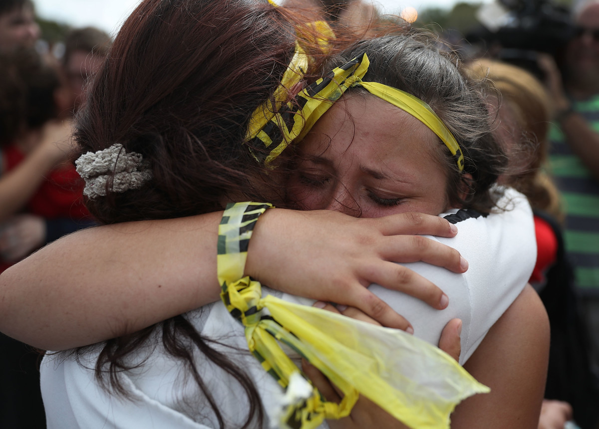 Madison Fox is hugged as the West Boca High School student joined hundreds of fellow students that walked to Marjory Stoneman Douglas High School in honor of the 17 students shot dead on February 20th, 2018, in Parkland, Florida.