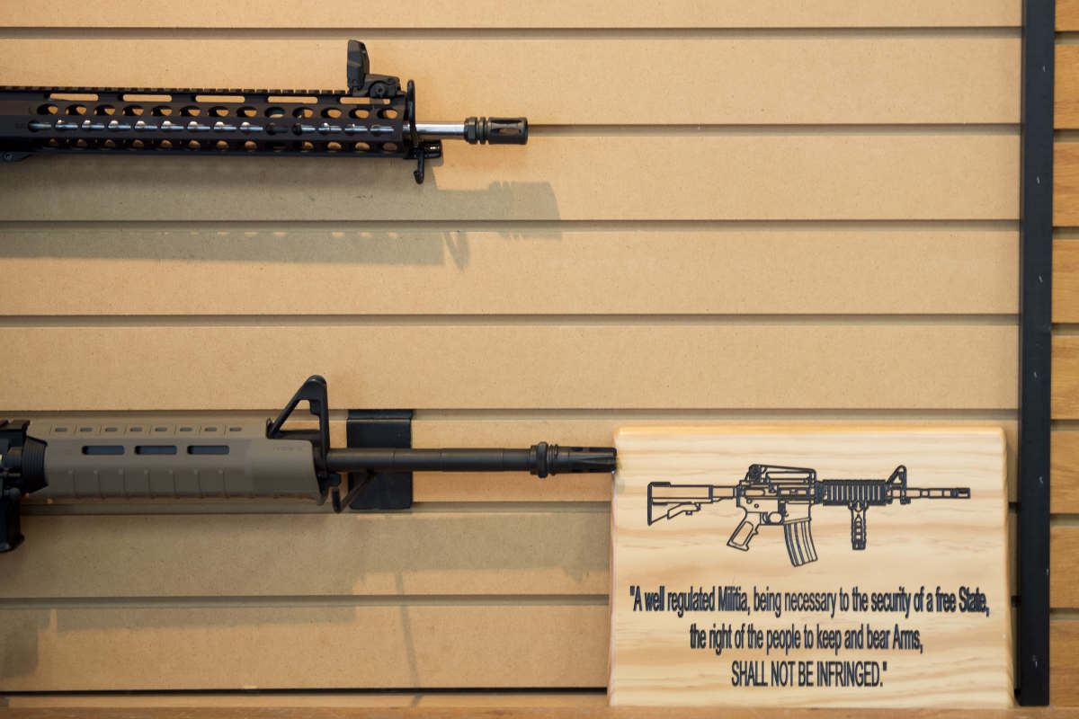 A placard about gun rights hangs on the wall next to assault rifles for sale at Blue Ridge Arsenal in Chantilly, Virginia, on October 6th, 2017.