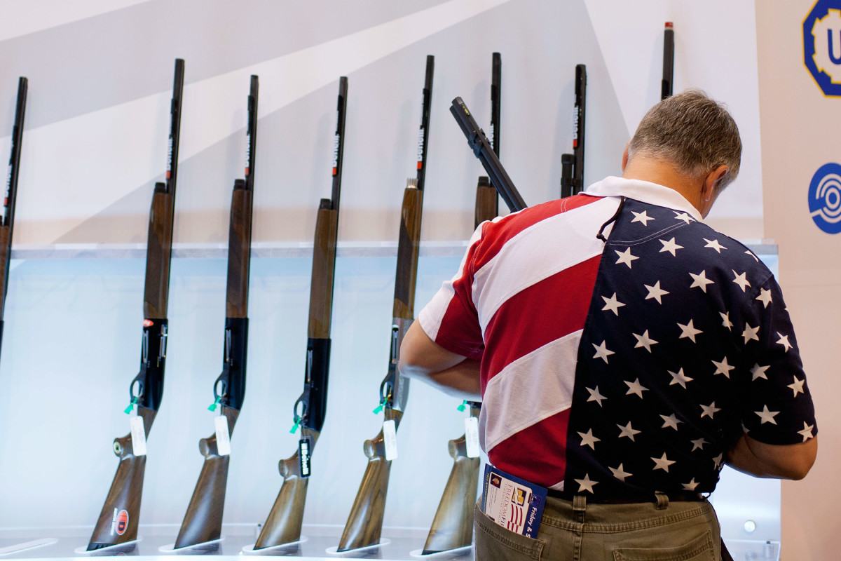 A man looks at the Benelli display of shotguns during the NRA Annual Meetings and Exhibits convention on April 13th, 2012, in St. Louis, Missouri.