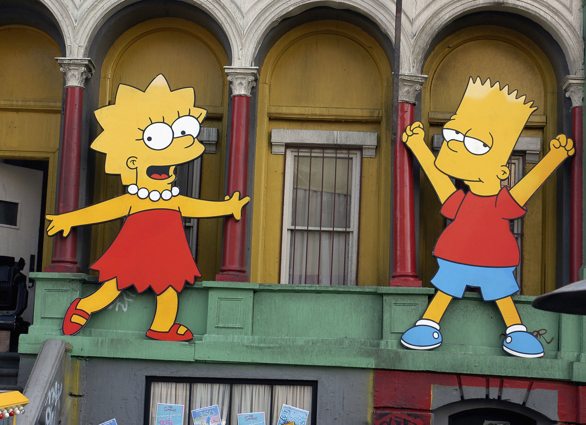 Lisa Simpson and Bart Simpson cut-outs on display at a block party in Los Angeles, California.