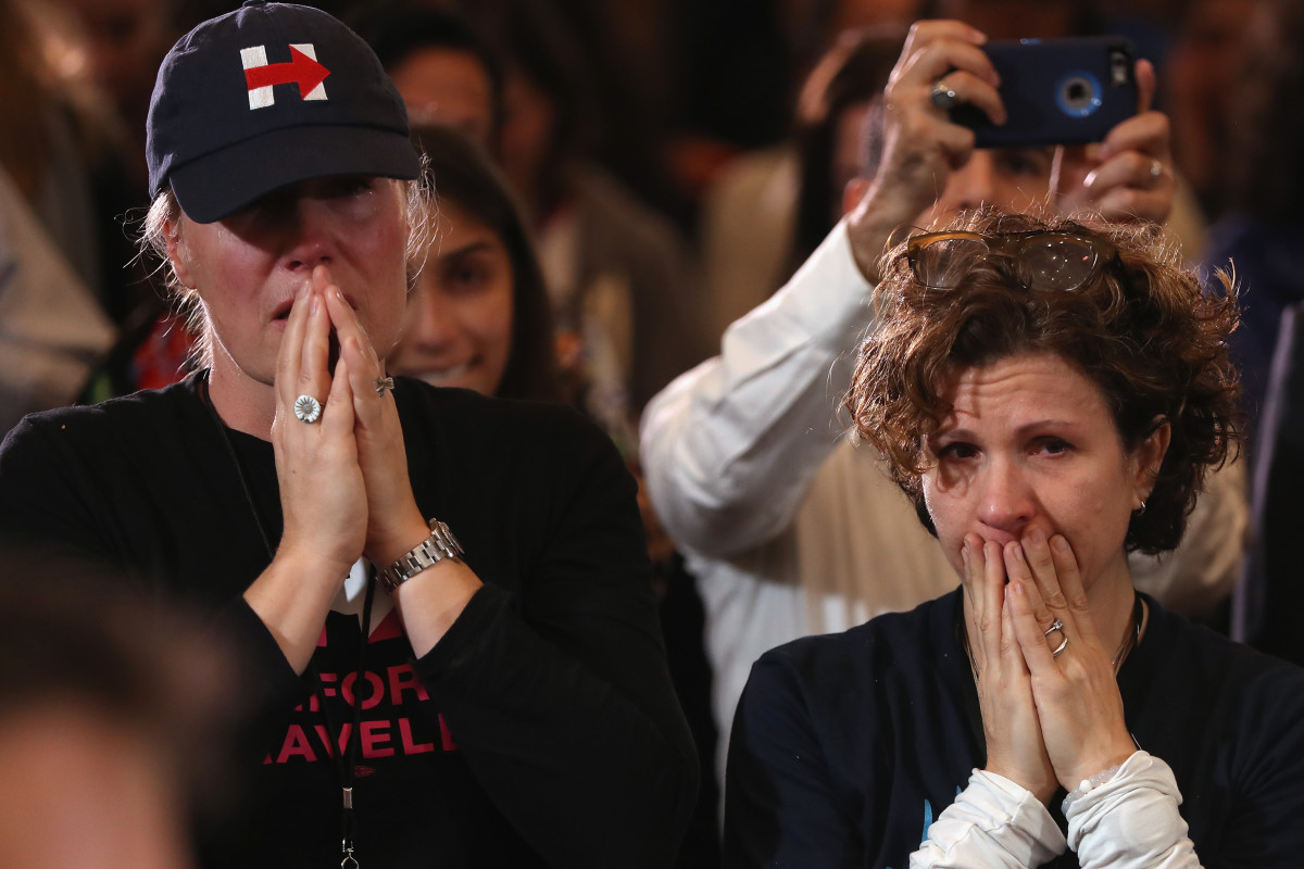 Staffers and supporters react as former Secretary of State Hillary Clinton concedes the presidential election at the New Yorker Hotel on November 9, 2016 in New York City. Republican candidate Donald Trump won the 2016 presidential election in the early hours of the morning in a widely unforeseen upset.