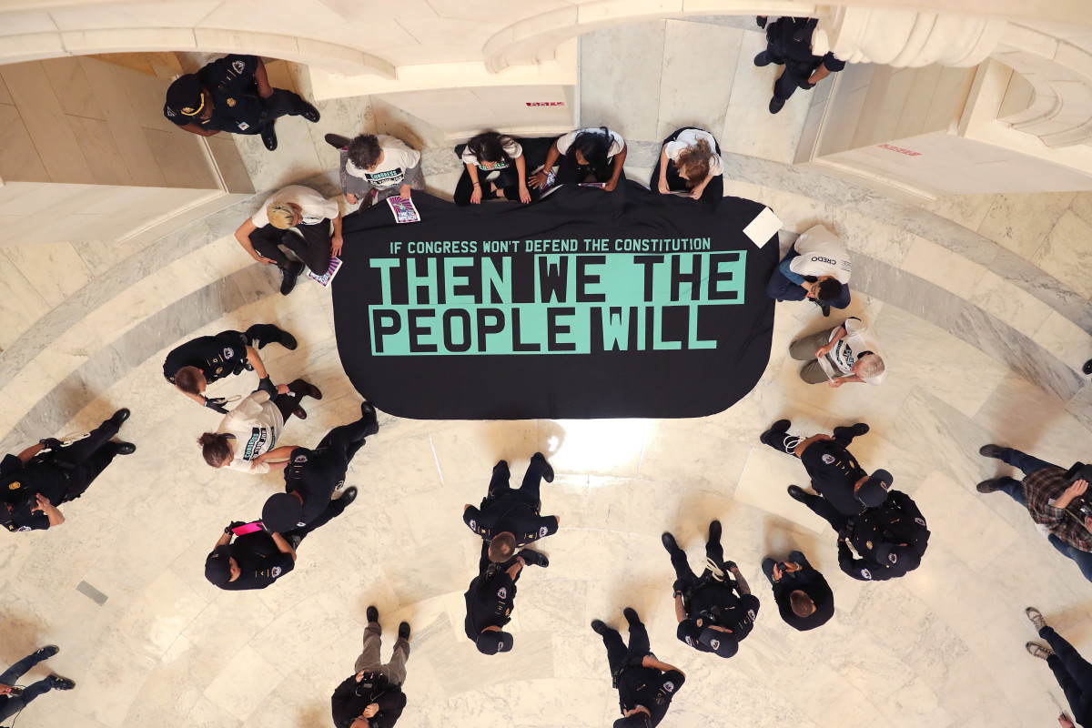 Demonstrators from the pro-impeachment group By the People rally in the Cannon House Office Building Rotunda on Capitol Hill on May 14th, 2019, in Washington, D.C. About 10 members of the protest group were arrested by U.S. Capitol Police while demanding that impeachment proceedings against President Donald Trump begin immediately.
