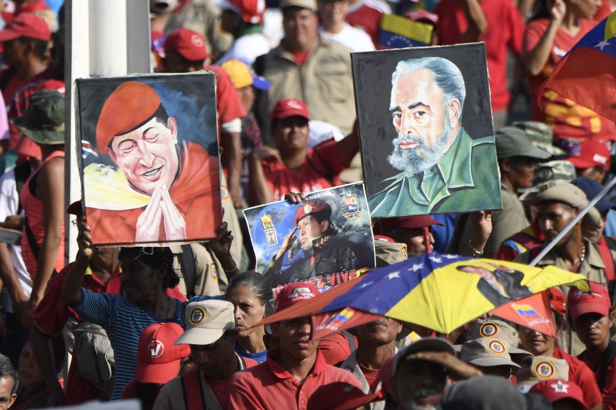 Portraits depicting late Venezuelan President Hugo Chávez and the late Cuban leader Fidel Castro on display during a May Day rally in Caracas, Venezuela, on May 1st, 2019.