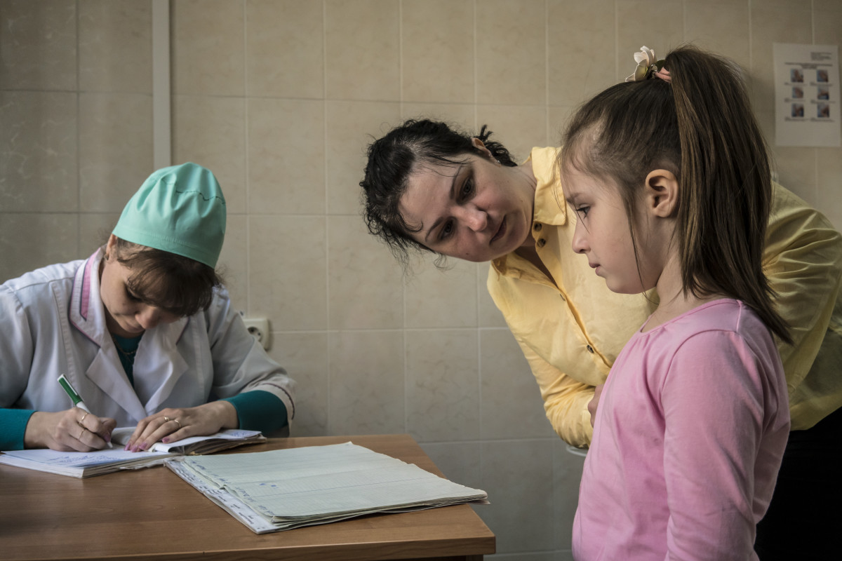 Katya Ganiyeva tends to her daughter Alisa Ganiyeva, age six, who is about to receive a measles vaccine shot from nurse Mariana Gonchara at a health clinic on May 15th, 2019, in Kiev, Ukraine. Ukraine is struggling with its largest measles outbreak in decades, with more than 34,000 confirmed cases so far this year, according to the World Health Organization.