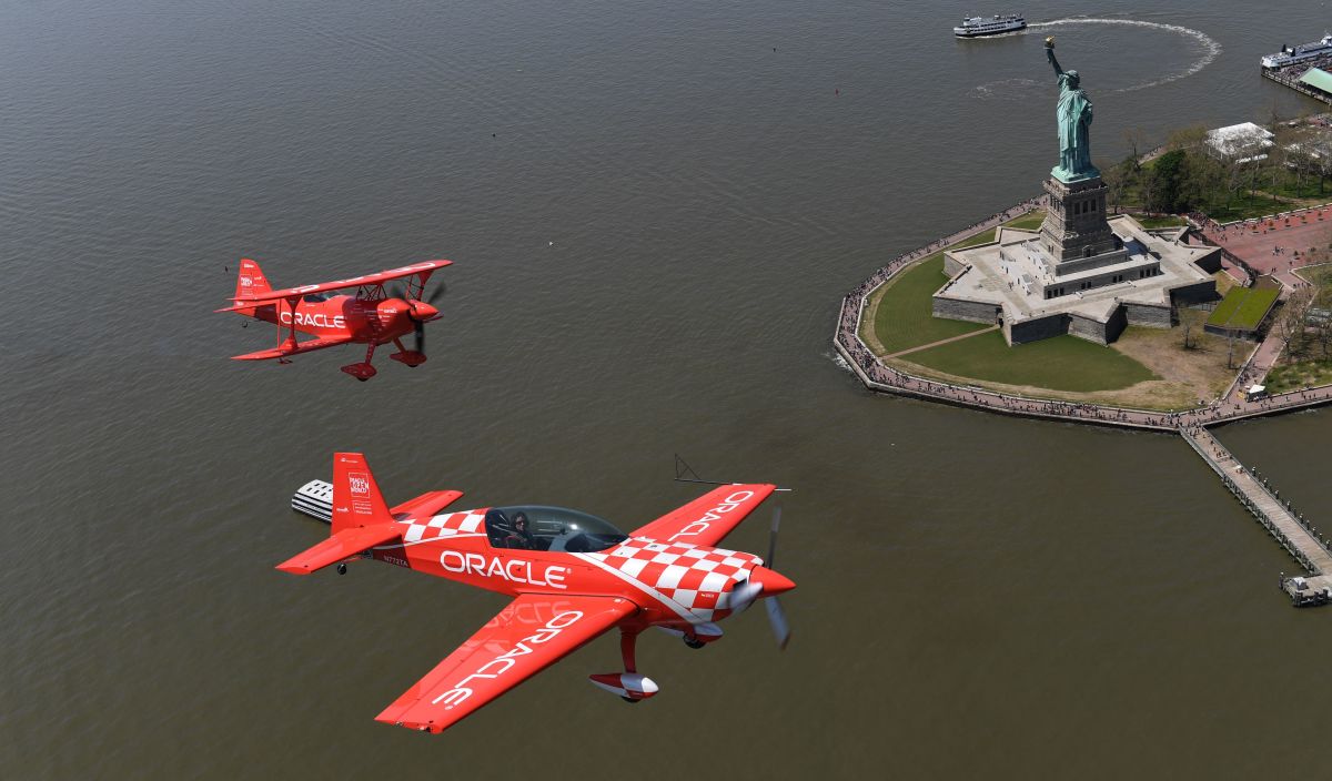 Aerobatic pilots Sean D. Tucker and Jessy Panzer (foreground) of Team Oracle fly down the Hudson River past the Statue of Liberty on May 22nd, 2019, during a media day in advance of the Bethpage Air Show at Jones Beach over Memorial Day weekend.
