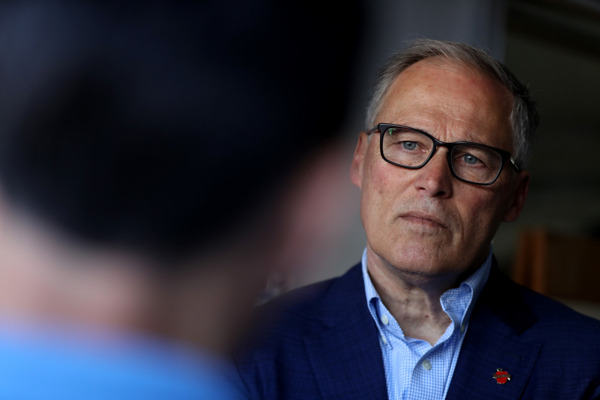 Democratic presidential candidate Washington Governor Jay Inslee talks with solar workers at a home where they recently installed solar panels on May 2nd, 2019, in San Francisco, California.