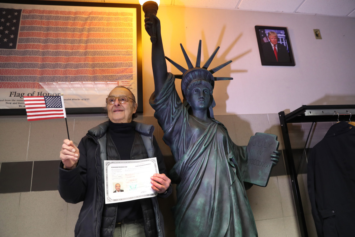 A new American citizen poses for photos following a naturalization ceremony on February 2nd, 2018, in New York City.