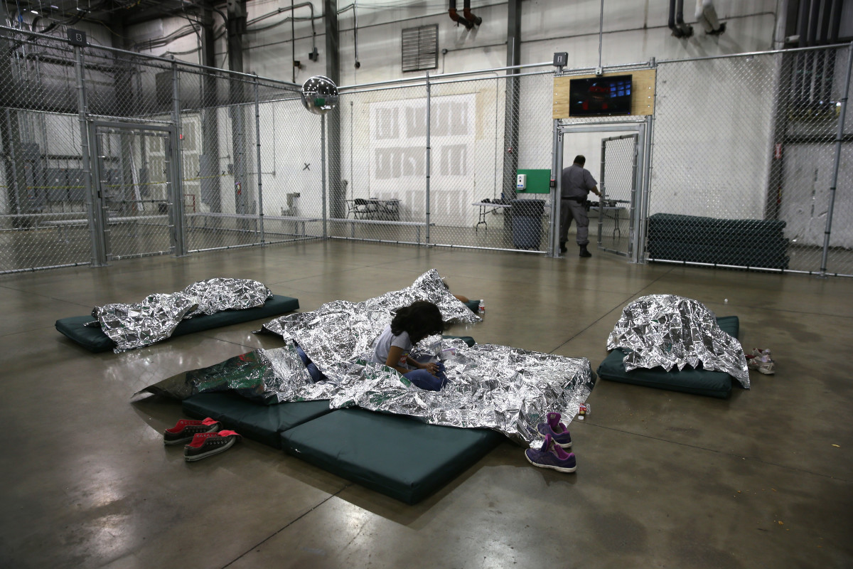 A girl from Central America rests on thermal blankets at a detention facility run by the U.S. Border Patrol on September 8th, 2014, in McAllen, Texas.