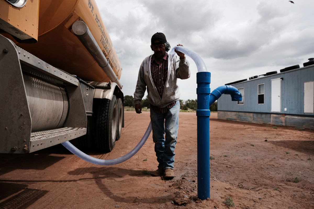 Cecil Joe, a member of the Navajo Nation, fills a water tank supplying one Navajo household on June 5th, 2019, in Thoreau, New Mexico. Due to a legacy of poverty, marginalization, and disputed water rights, up to 40 percent of Navajo families don't have clean running water at home and are forced to rely on visits to water pumps.