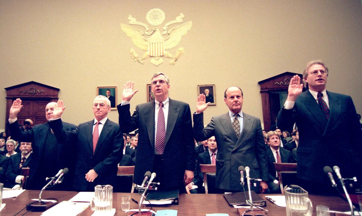 Five tobacco industry executives—Laurence Tisch, chief executive officer of the Loews Corporation; Geoffrey Bible, chairman of Philip Morris; Vincent Gierer Jr., chief executive officer of U.S. Tobacco; Steven Goldstone, chief executive officer of RJR Nabisco; and Nicholas Brooks, chairman of Brown & Williamson Tobacco Company—are sworn in before testifying before the House Commerce Committee on January 29th, 1998, in Washington, D.C.