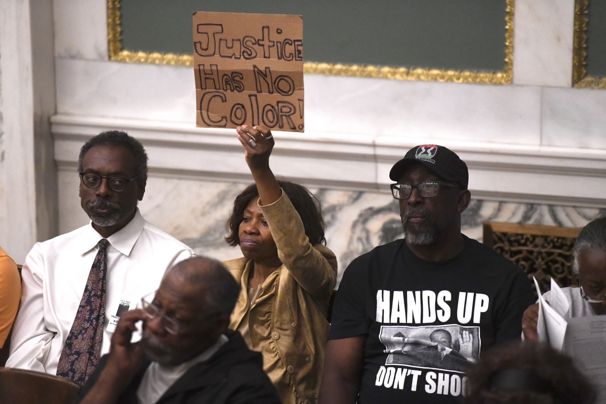 Demonstrators gather in the council chamber to protest in front of councilmen and councilwomen at Philadelphia City Hall on June 20th, 2019, in Philadelphia, Pennsylvania. Philadelphia police have confirmed that more than 70 officers have been placed on desk duty while authorities investigate alleged racist and violent social media posts that were unearthed by the Plain View Project.
