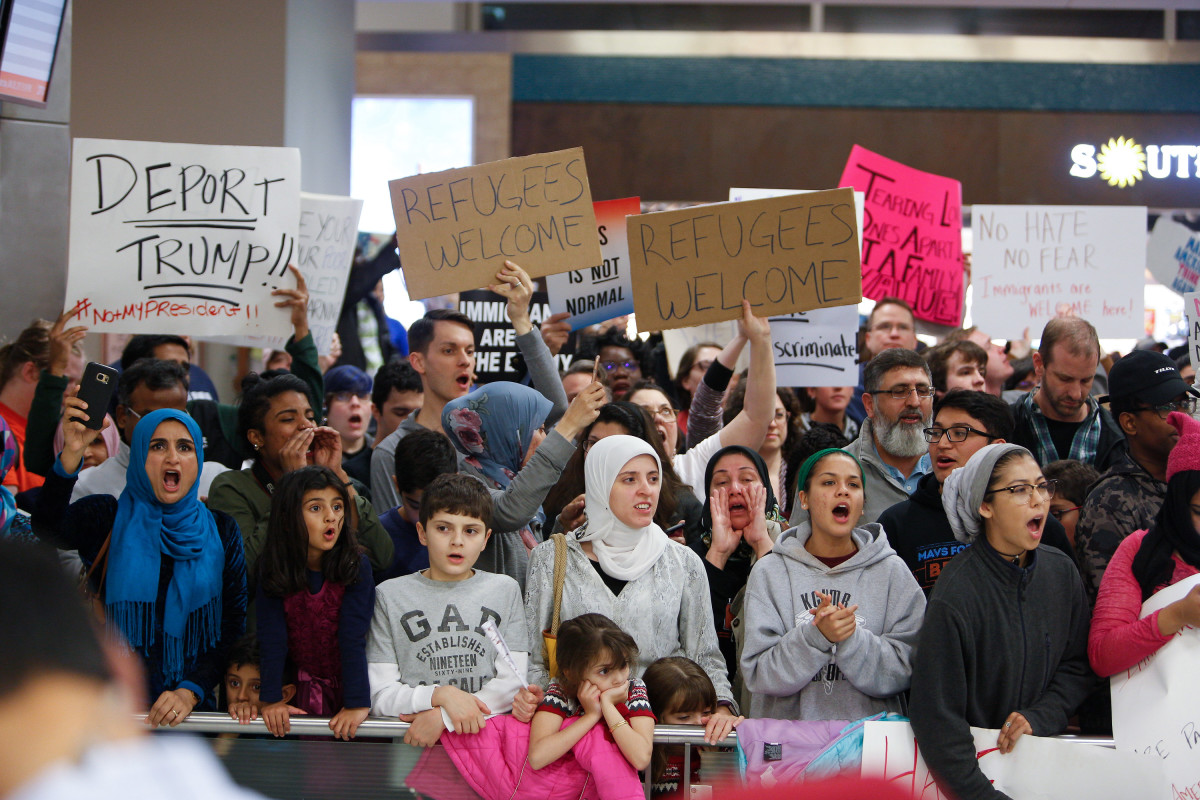 Protesters gather to denounce President Donald Trump's executive order that bans certain immigration, at Dallas-Fort Worth International Airport, on January 28th, 2017 in Dallas, Texas.