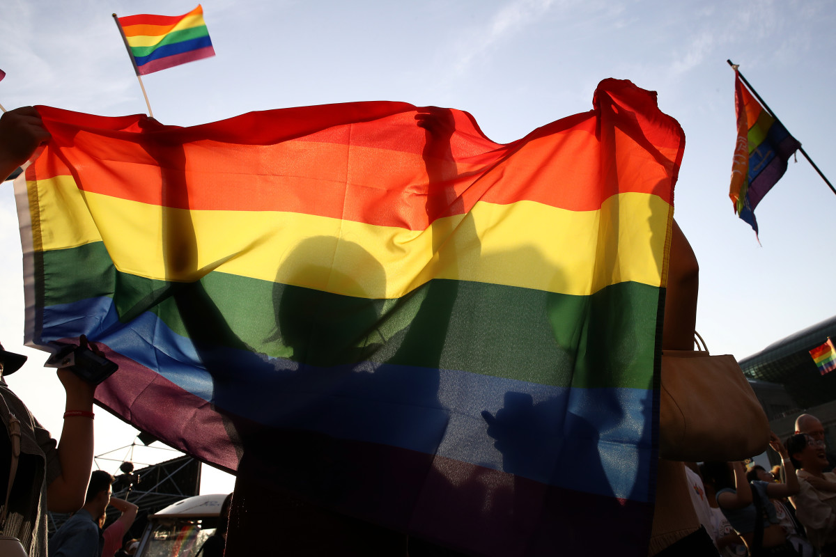 People wave a rainbow Pride flag during the Korea Queer Culture Festival on June 1st, 2019, in Seoul, South Korea.