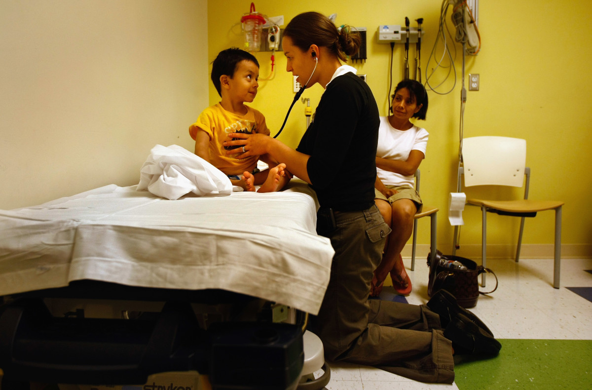 A nurse checks a child's heartbeat in the emergency room of the Children's Hospital in Aurora, Colorado.