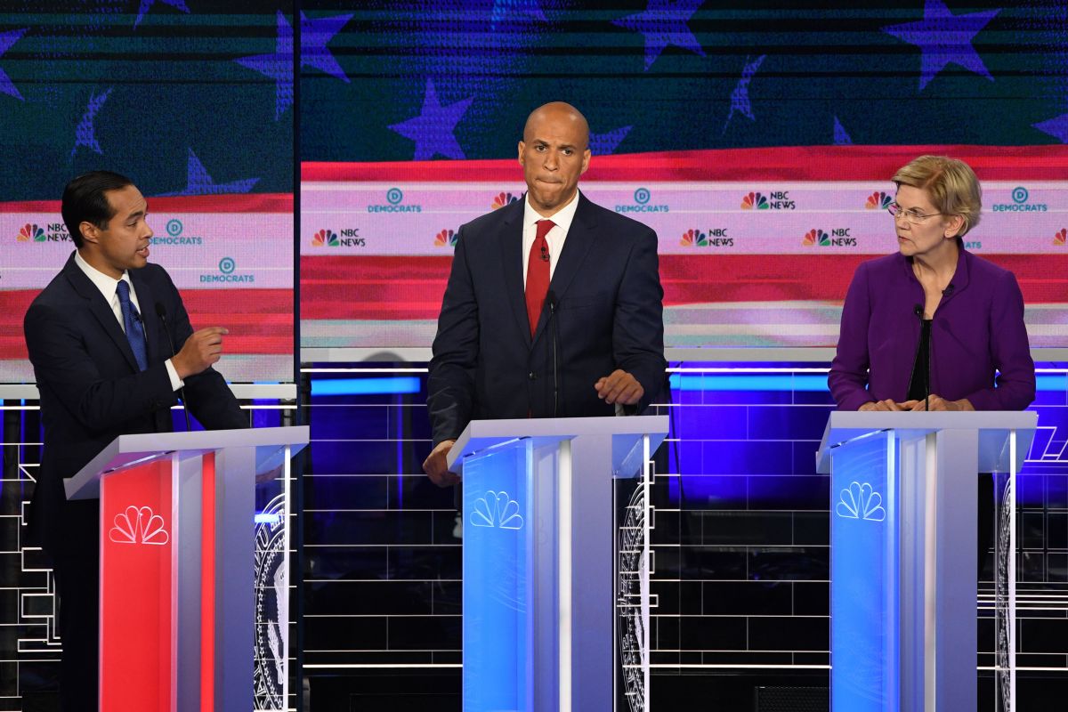 Democratic presidential hopeful and former Secretary of Housing and Urban Development Julián Castro (left) speaks as New Jersey Senator Cory Booker and Massachusetts Senator Elizabeth Warren listen during the first Democratic primary debate of the 2020 presidential campaign season at the Adrienne Arsht Center for the Performing Arts in Miami, Florida, on June 26th, 2019.