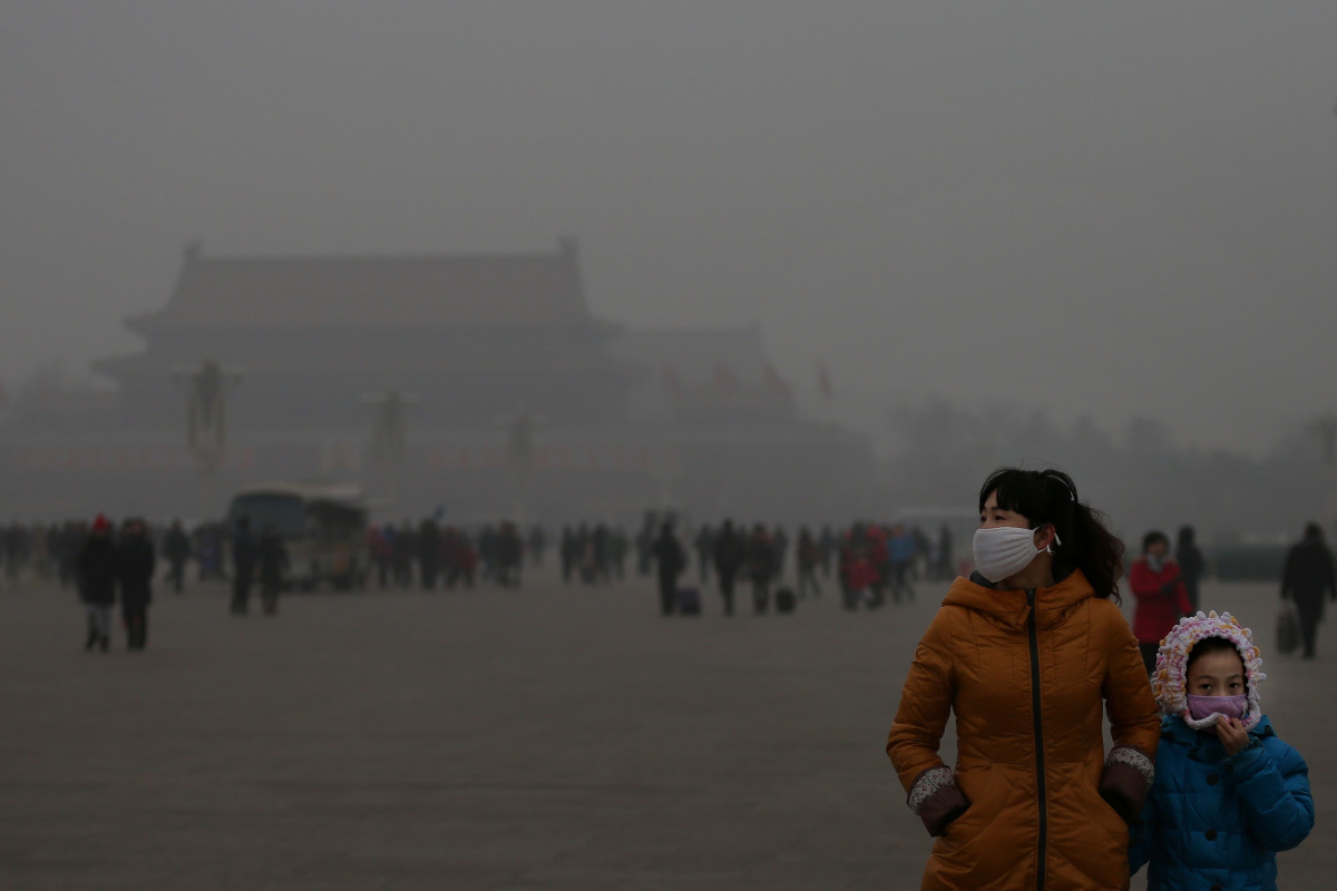 A tourist and her daughter wearing masks visit Tiananmen Square at dangerous levels of air pollution on January 23rd, 2013, in Beijing, China.