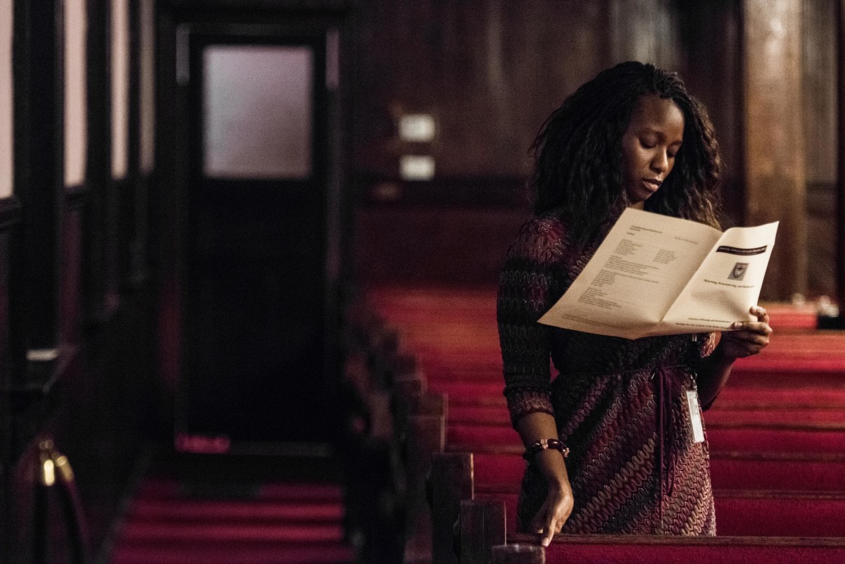 A woman reads a program during a memorial service honoring the victims of the mass shooting at Emanuel African Methodist Episcopal Church, a year after the massacre, on June 17th, 2016, in Charleston, South Carolina.