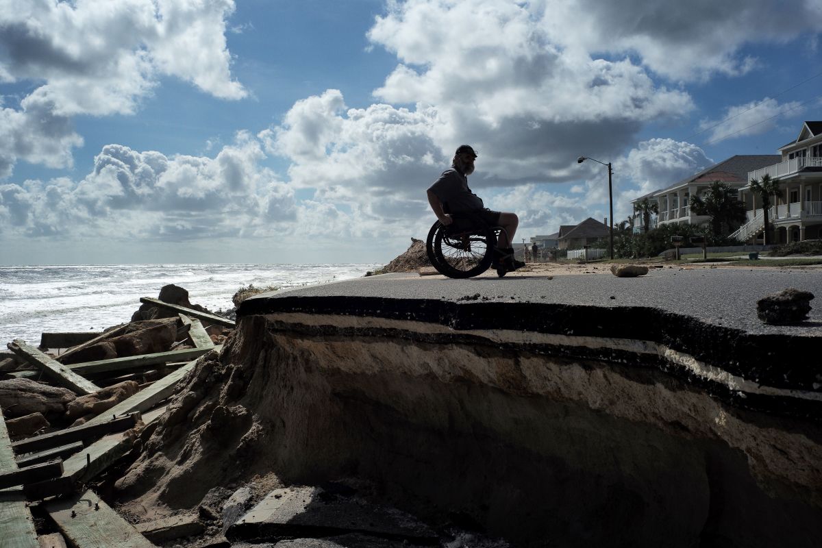 Bug Mohani steers his wheelchair along a part of a highway washed out by Hurricane Matthew in Flagler Beach, Florida, on October 9th, 2016.
