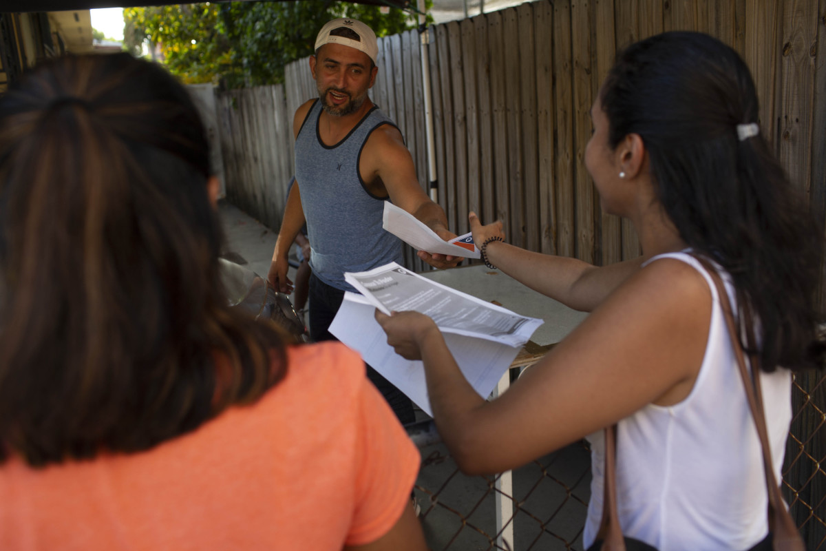 Immigration advocates with the Florida Immigrant Coalition go house to house handing out fliers on July 13th, 2019, in Little Havana in Miami, Florida.