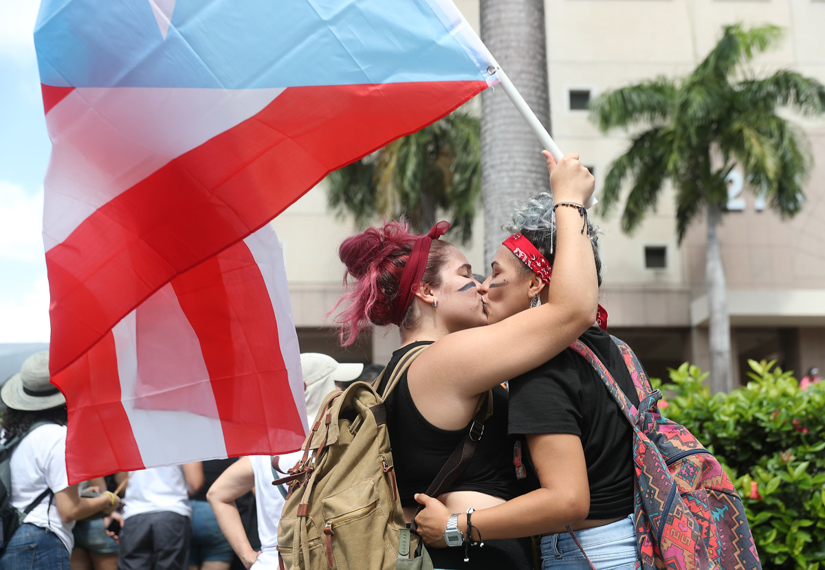 Isamar Sepulveda and Adriana Hernandez embrace as they join with other people to celebrate the ousting of Ricardo Rosselló, the governor of Puerto Rico, on July 25th, 2019, in Old San Juan. Rosselló stepped down after a group chat was exposed that included misogynistic and homophobic comments.