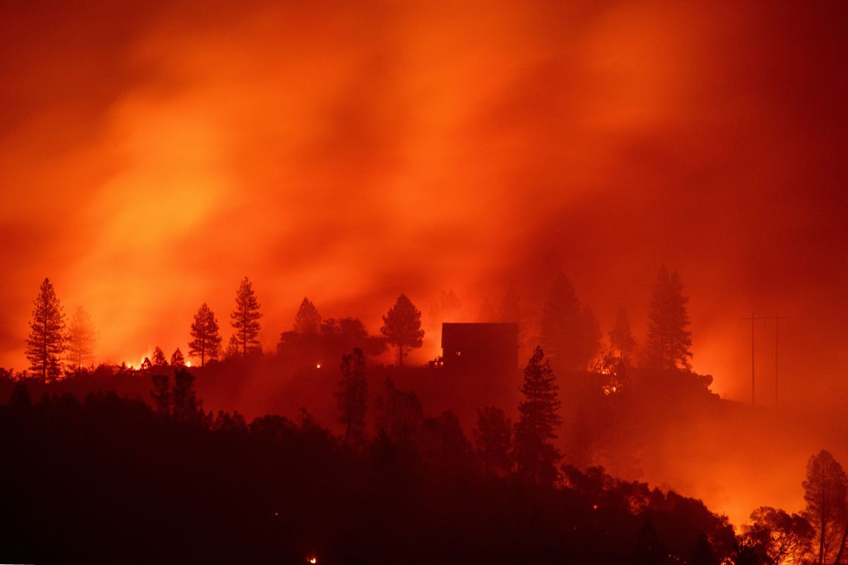 Flames from the Camp Fire burn near a home atop a ridge near Big Bend, California, on November 10th, 2018.