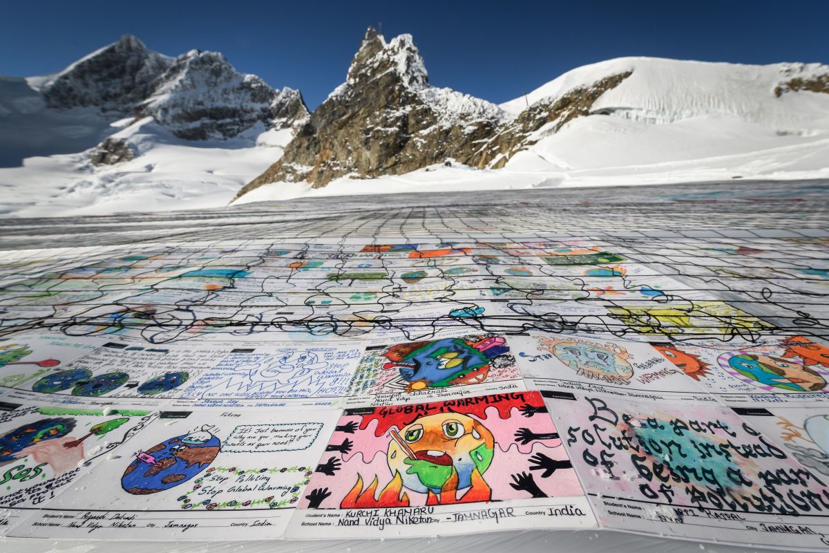 An aerial view shows a massive collage of 125,000 drawings and messages from children around the world, displayed on the Aletsch Glacier near the Jungfraujoch in the Swiss Alps, on November 16th, 2018. The mosaic of postcards, measuring 26,910 square feet, was laid out in the snow to boost a global youth climate movement ahead of COP24 in Poland.