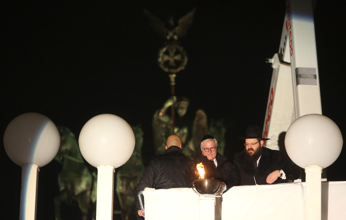 Rabbi Yehuda Teichtal (right) and German President Frank-Walter Steinmeier light Europe's largest menorah during a public lighting ceremony on the first night of Hanukkah, on December 2nd, 2018, in Berlin, Germany.