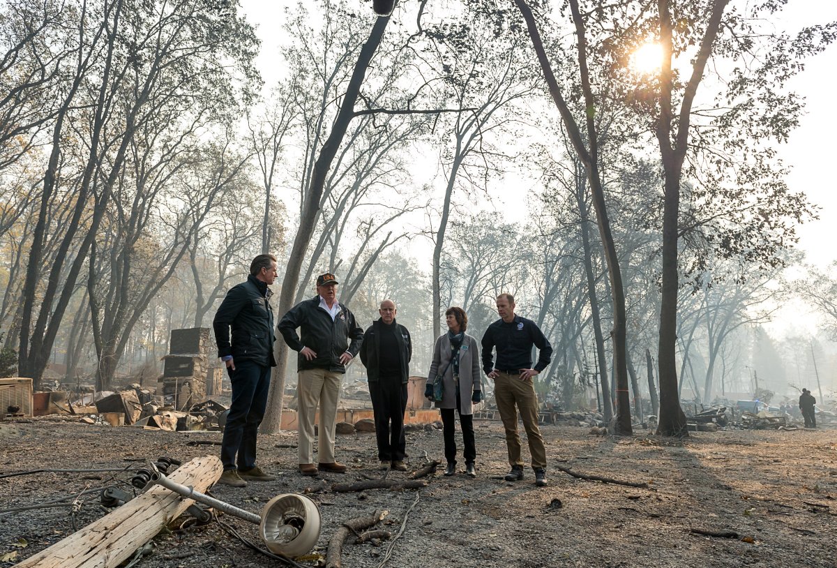 Governor-elect Gavin Newson, President Donald Trump, Governor Jerry Brown, Paradise Mayor Jody Jones and Federal Emergency Management Agency Director Brock Long tour an RV park during Trump's visit of the Camp Fire in Paradise, California, on November 17th, 2018.