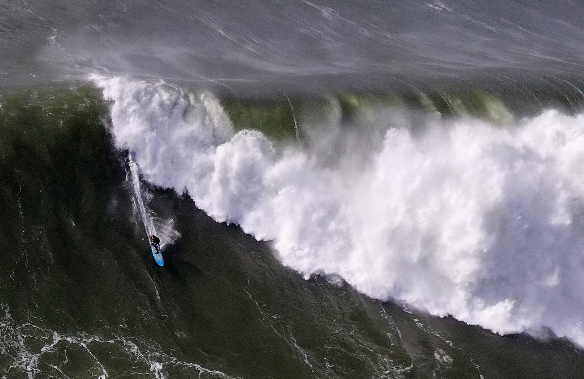A surfer rides a wave at the famous Mavericks surf break on December 17th, 2018, in Half Moon Bay, California. A giant swell brought waves of up to 50 feet high to Northern California.