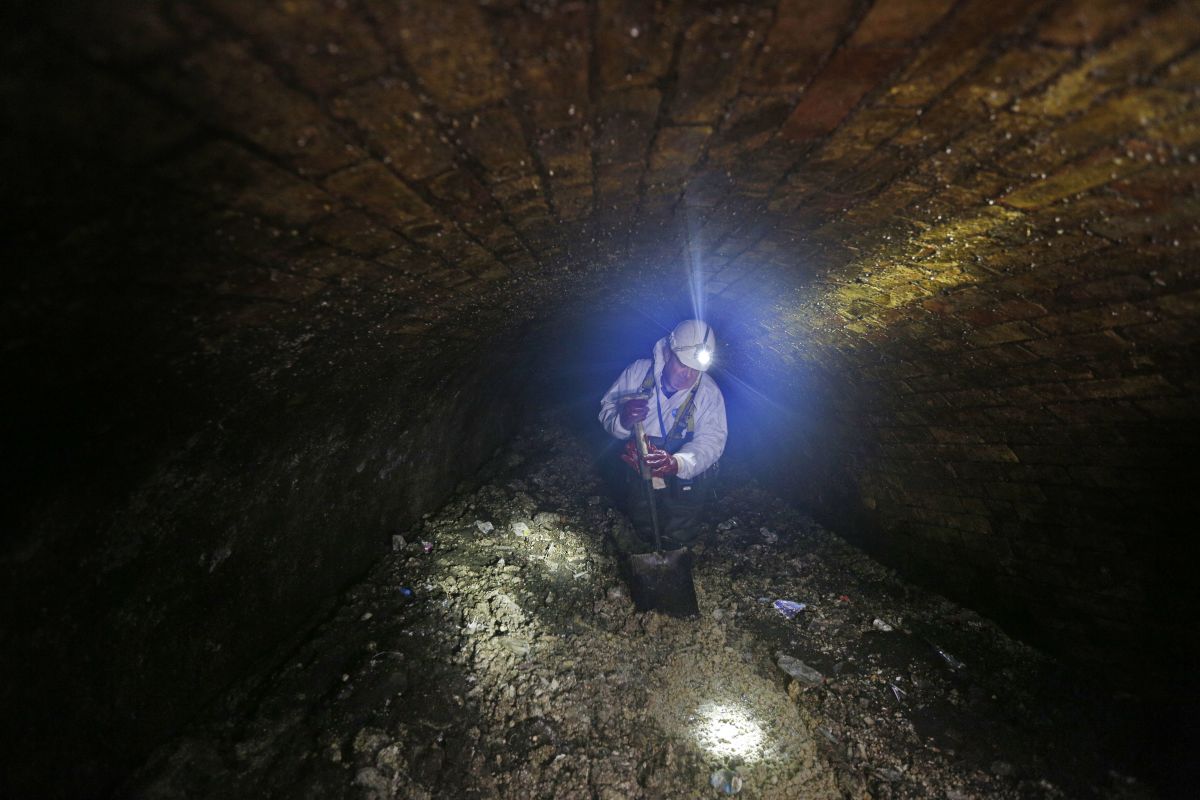 Vince Minney works in the sewers in London on December 11th, 2014, fighting against the fatbergs clogging the system.