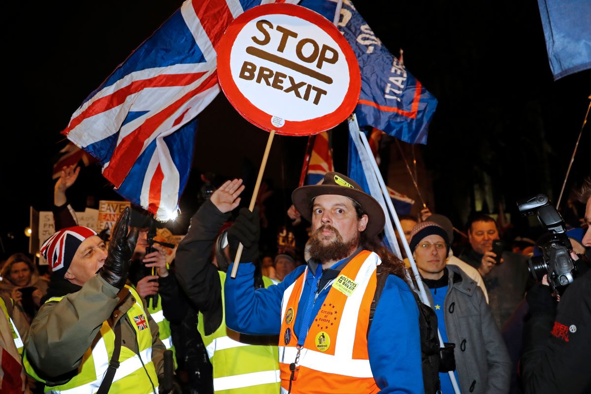A pro-Brexit activist (left) addresses an anti-Brexit activist (center) as both sides demonstrate outside of the Houses of Parliament in London on January 29th, 2019.