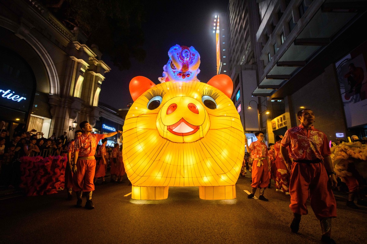 Performers walk with a lit model of a pig during the annual Lunar New Year parade in the Kowloon district of Hong Kong on February 5th, 2019, to mark the Year of the Pig.