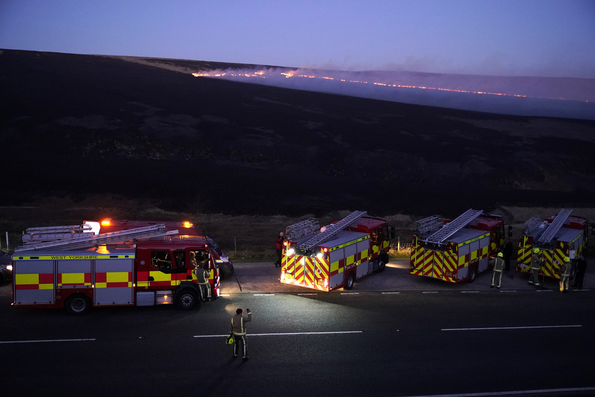 Fire trucks are seen at the site of the Saddleworth Moor fire on February 27th, 2019, near Marsden, England.