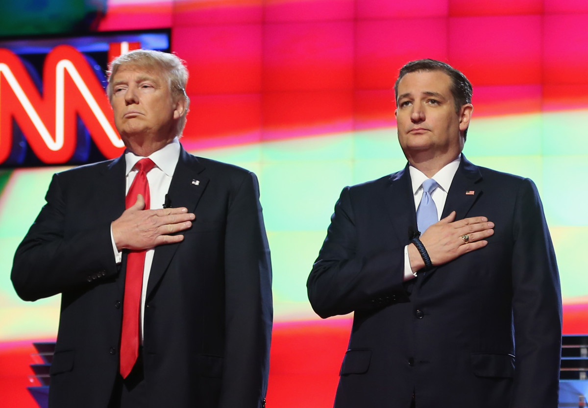 President Donald Trump and Senator Ted Cruz listen to the national anthem.