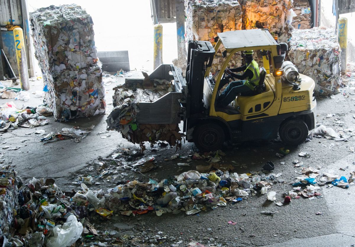 Workers sort recycling material at the Waste Management Material Recovery Facility in Elkridge, Maryland, on June 28th, 2018.