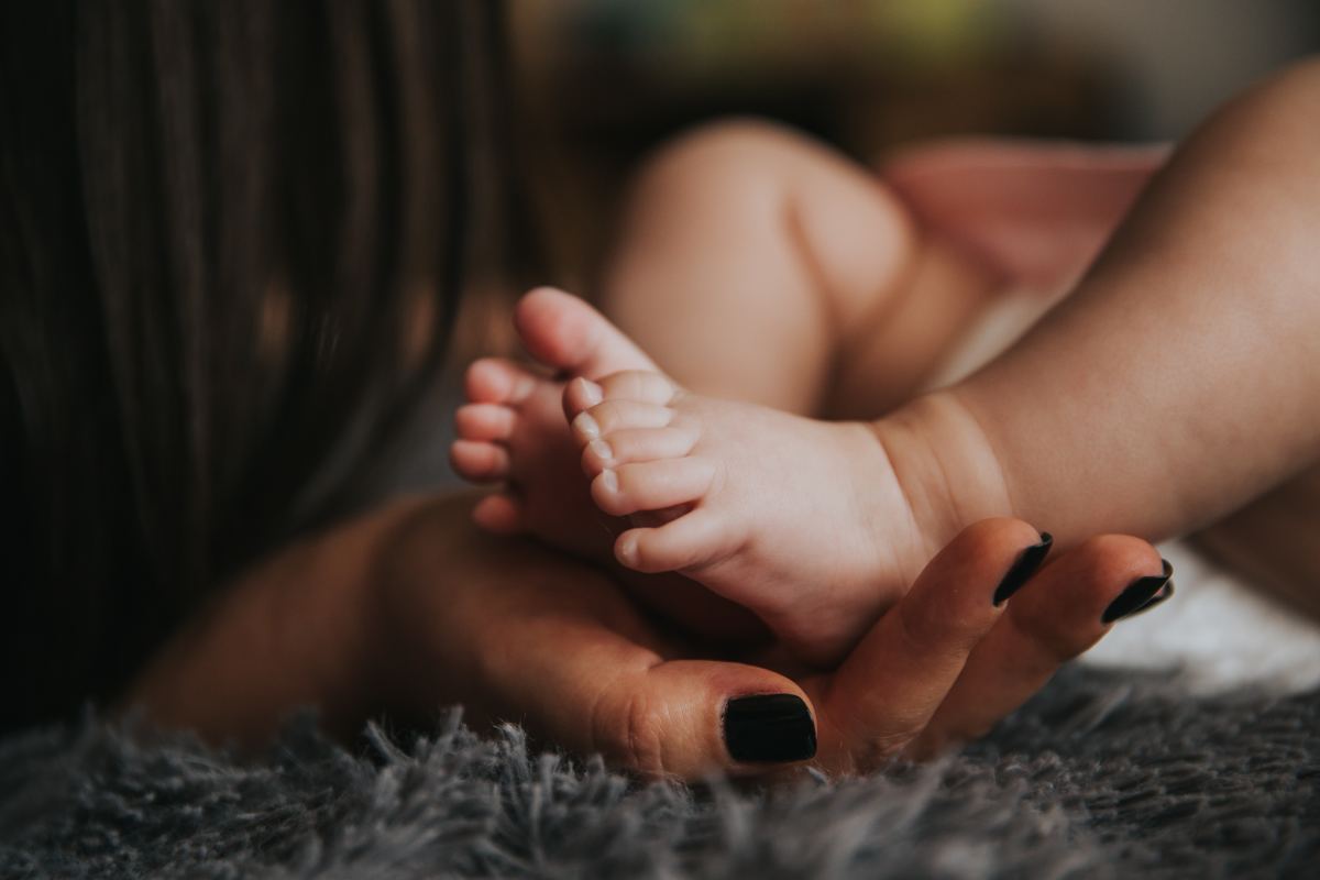 Mother holding baby's feet