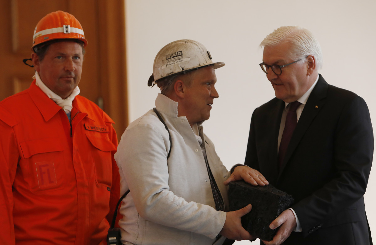 Coal miners give German President Frank-Walter Steinmeier a symbolic final chunk of coal in a ceremony at Schloss Bellevue presidential palace on April 3rd, 2019, in Berlin, Germany. Germany's last underground coal mine, located in the Ruhr region, closed in December. However, Germany still mines large amounts of lignite coal from open cast mines near Cologne and in eastern Germany.