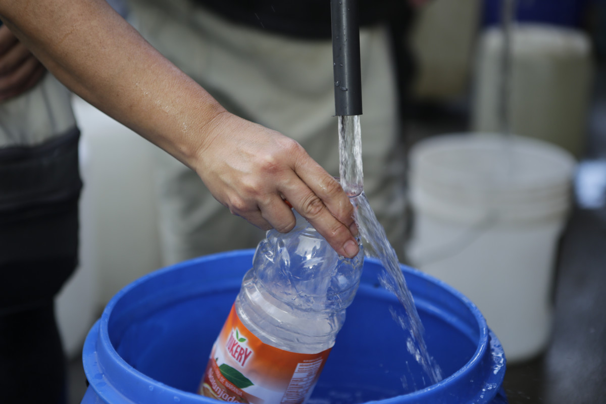 A bottle is being filled with water from tanks in a service area organized to help the community by the Ministry of Popular Power for Ecosocialism and Waters in Parque del Este, on April 4th, 2019 in Caracas, Venezuela.