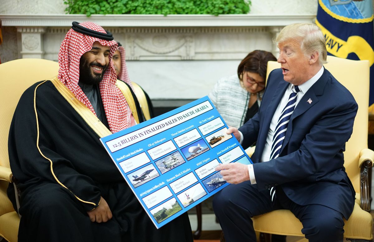 President Donald Trump looks at a defense sales chart with Saudi Arabia's Crown Prince Mohammed bin Salman in the Oval Office of the White House on March 20th, 2018.