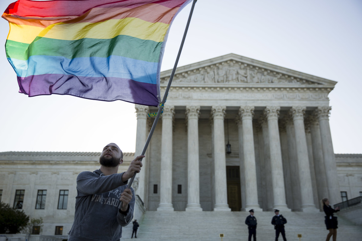 A same-sex marriage supporter waves a rainbow pride flag near the Supreme Court, on April 28th, 2015, in Washington, D.C., just days before the Supreme Court heard arguments on same-sex marriage.