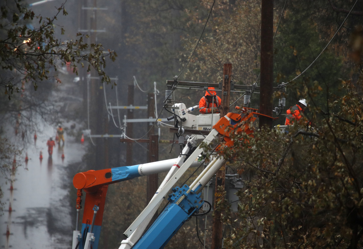 PG&E crews repair power lines that were destroyed by the Camp Fire on November 21st, 2018, in Paradise, California.
