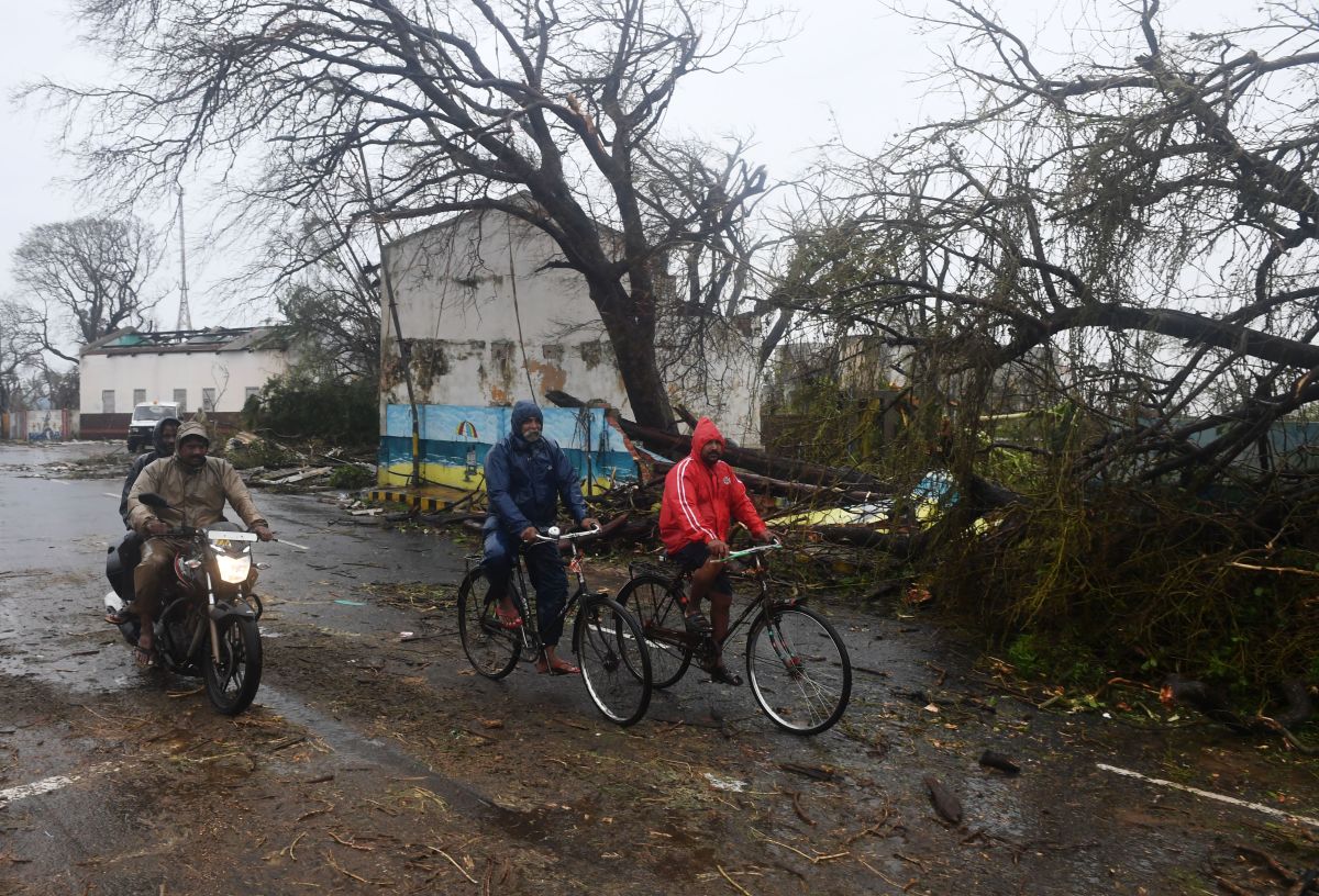 Indian residents ride along a road next to damaged trees after Cyclone Fani landfall in Puri in the eastern Indian state of Odisha on May 3rd, 2019.