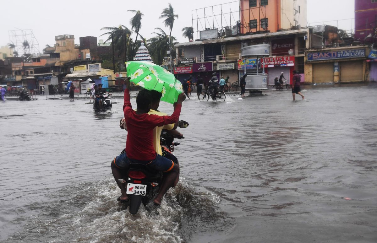 Indian residents ride on a bike along a flooded road after Cyclone Fani landfall in Puri, in the eastern Indian state of Odisha, on May 3rd, 2019.