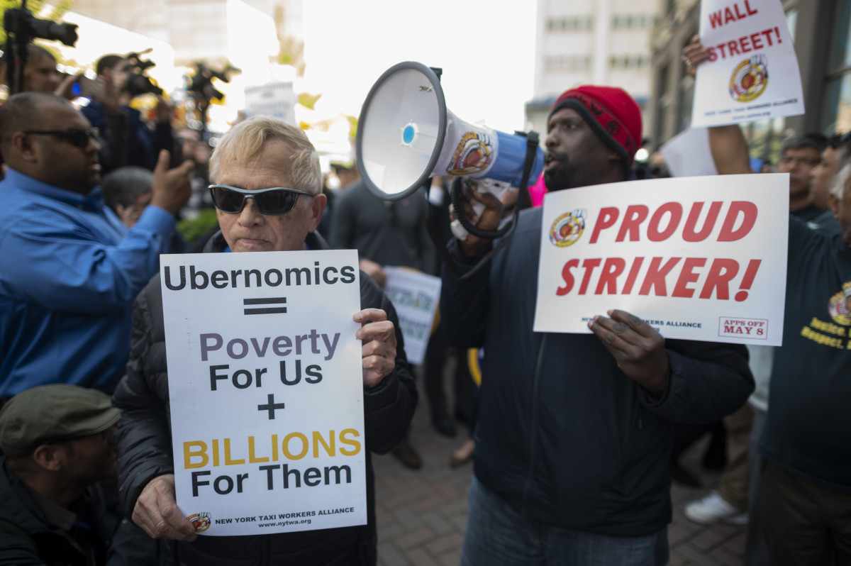 Drivers take part in a rally demanding more job security and livable incomes, at Uber and Lyft's New York City headquarters on May 8th, 2019. Rideshare drivers in major United States cities were set to stage a series of strikes and protests Wednesday, casting a shadow over the keenly anticipated Wall Street debut of sector leader Uber. Drivers for Uber, Lyft, Via, and other platforms are seeking improved job security, including an end to arbitrary deactivations, and a better revenue split between drivers and platforms.